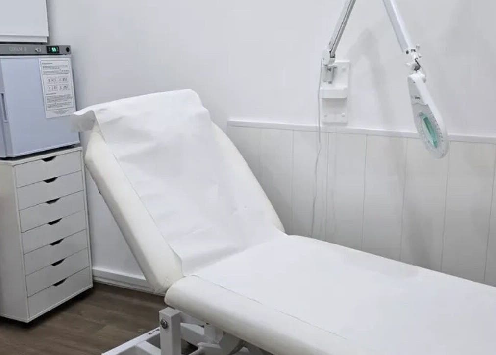Treatment room at Annayah Aesthetics, Brighton And Hove, England, GB, featuring a modern white chair and equipment.