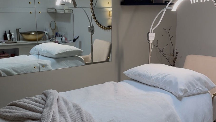 Elegant treatment room at Enhancedbeauty, Inverness, Scotland, GB, featuring plush bedding and ambient lighting.