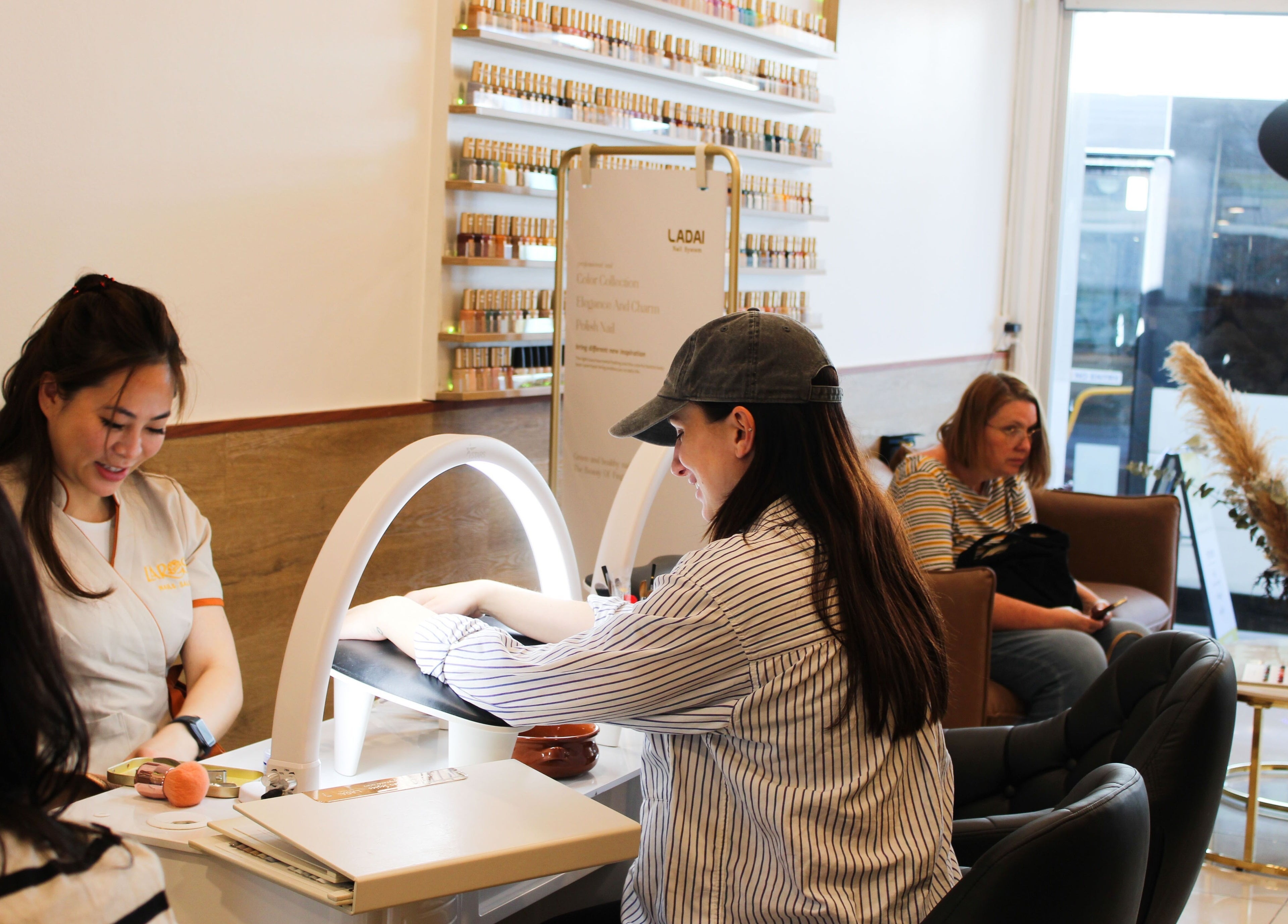 Customer enjoying manicure at Larose Nails Enmore, Enmore, New South Wales, AU. Cozy salon ambiance with service.
