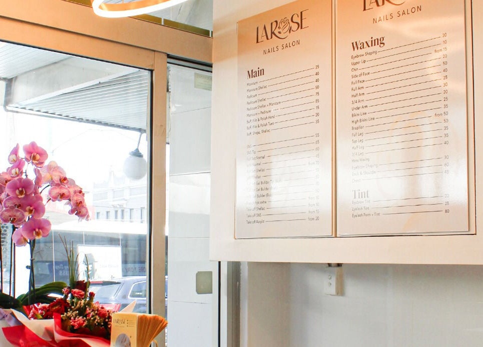 Interior view of Larose Nails Enmore showing colorful flowers and service menu in Enmore, New South Wales, AU.