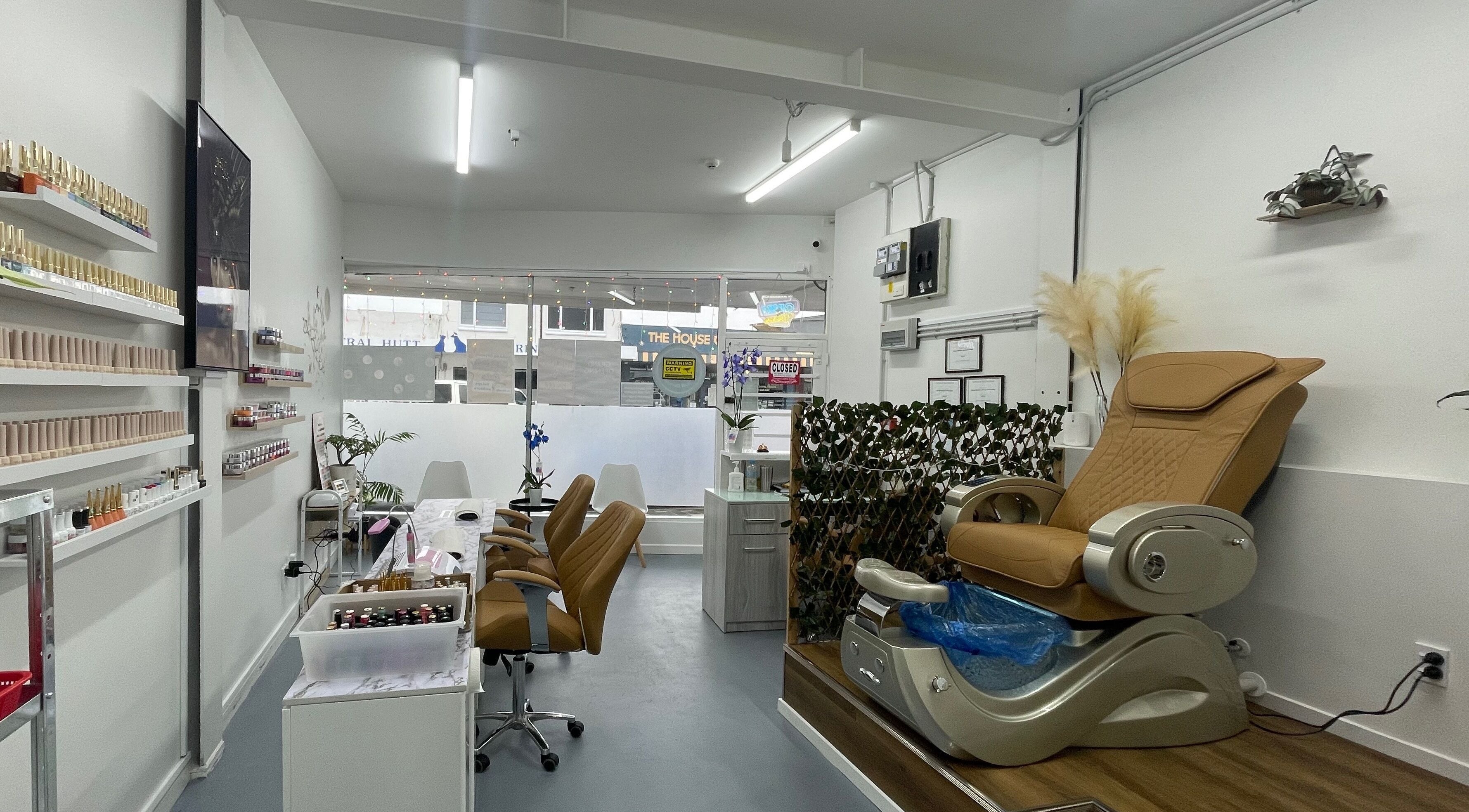 Relaxing interior of Nail Corner Studio in Lower Hutt, Wellington, NZ featuring elegant spa chairs and polish displays.