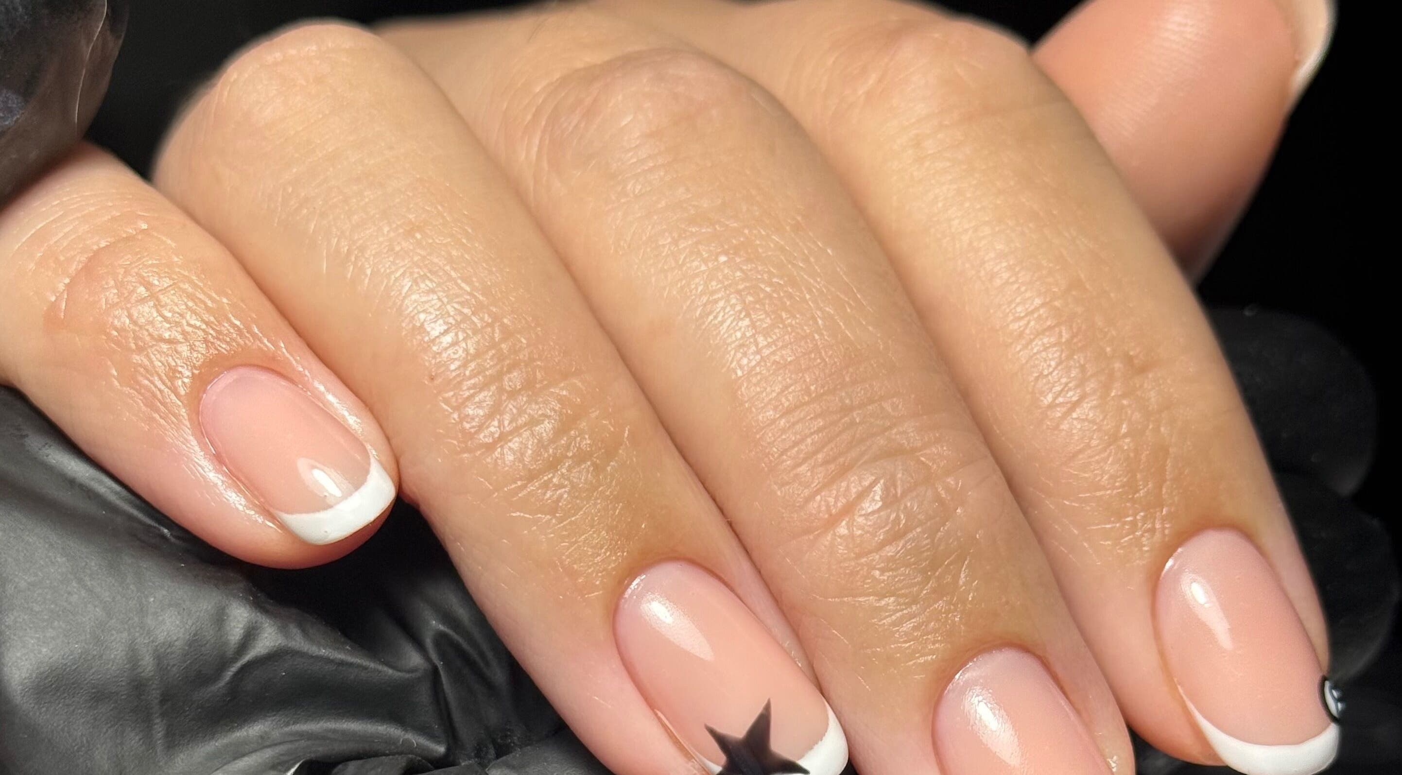 French manicure with a star design at Beauty Nook by Madie, Brabham, Western Australia, AU.
