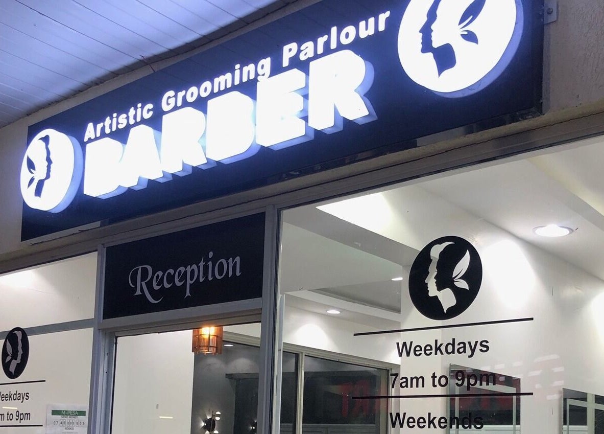 Exterior view of Artistic Grooming Parlour in Nairobi, Nairobi County, KE, showcasing illuminated signage.