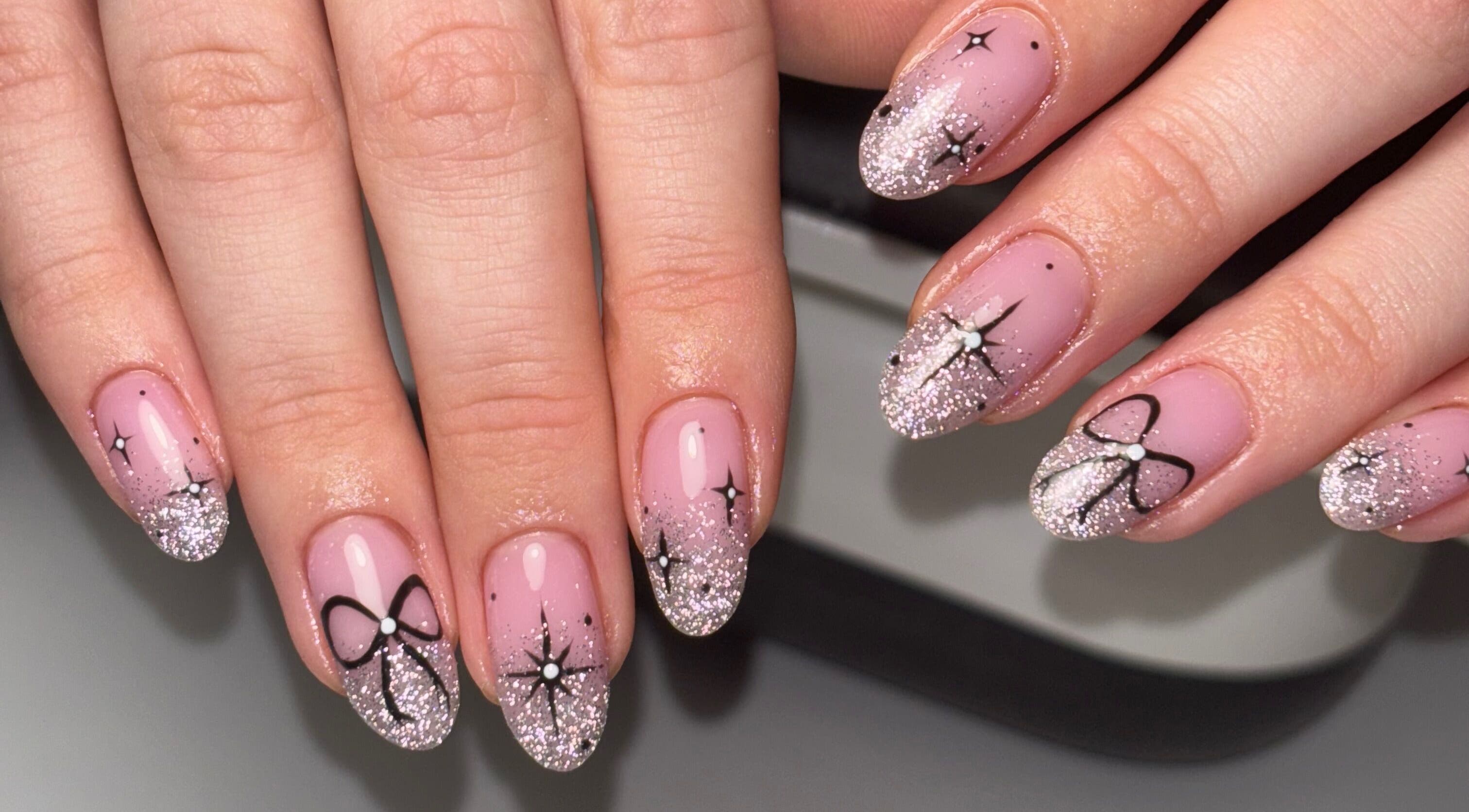 Elegant glitter bow nail art at Rogue Beauty, Hartlepool, England, GB.