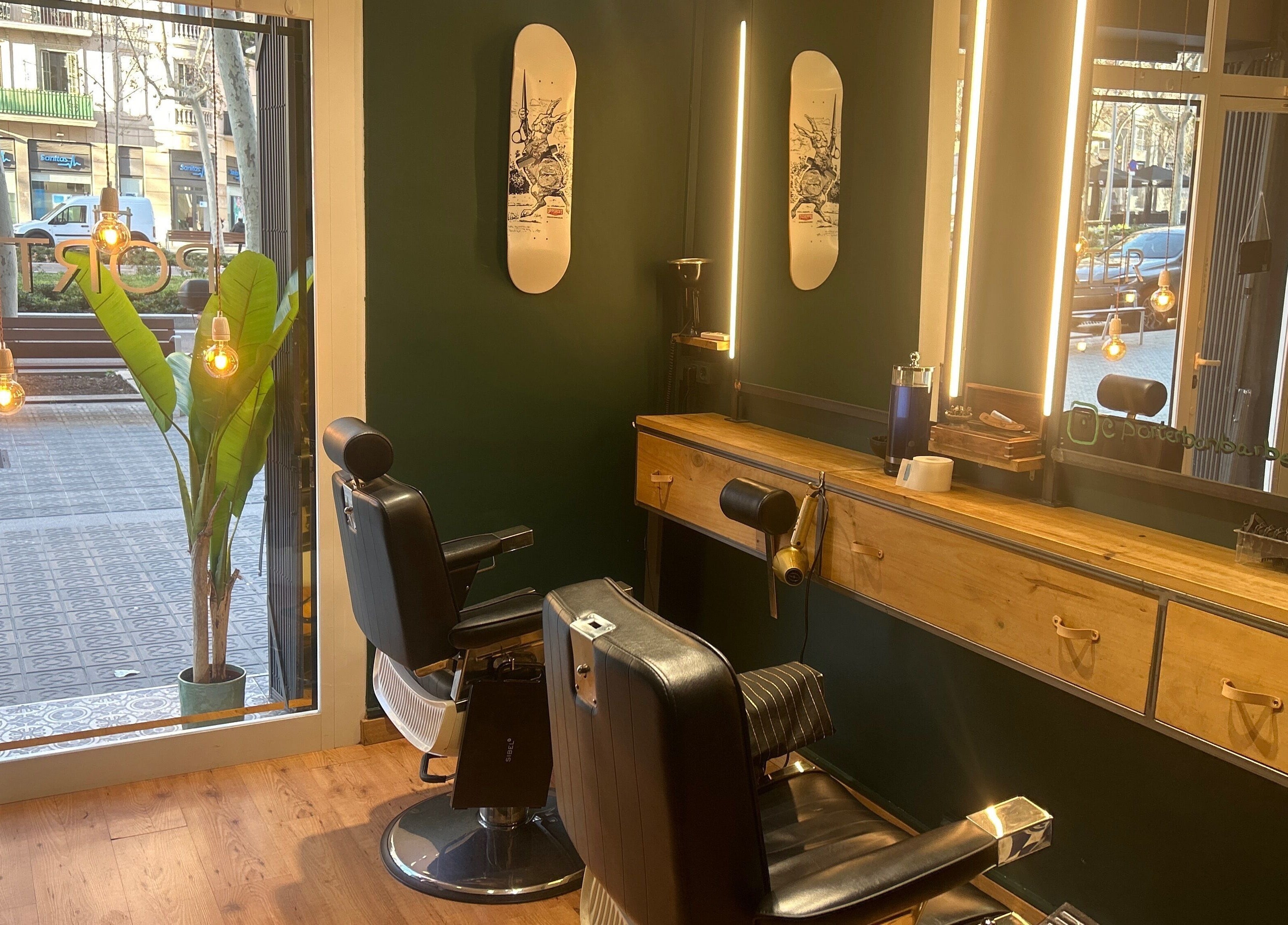 Stylish interior of Porter BCN Barbershop, Barcelona, Catalunya, ES with classic chairs and modern lighting.