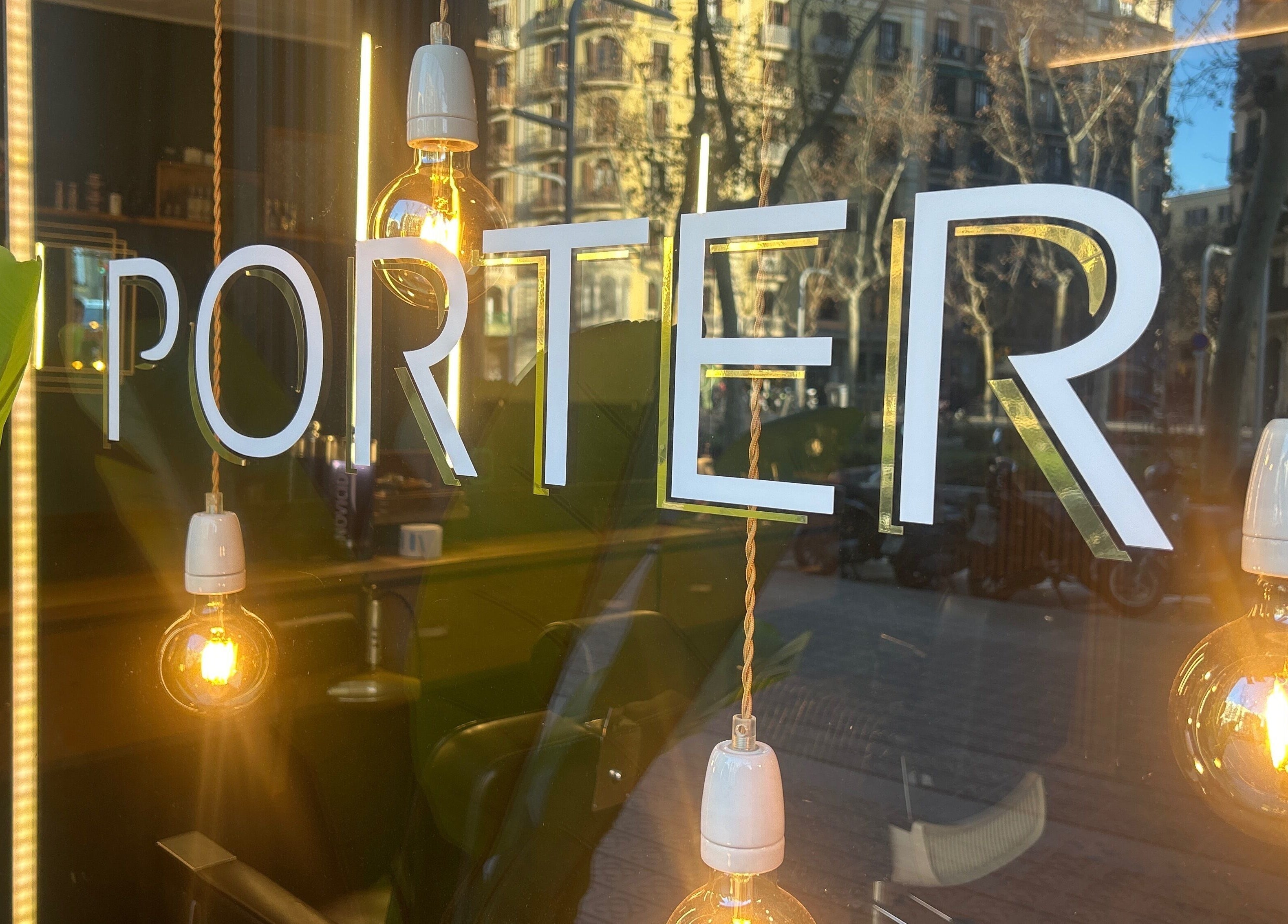 Exterior signage of Porter BCN Barbershop reflecting the city in Barcelona, Catalunya, ES.