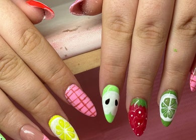 Vibrant fruit-themed nail art at Nails by Ariana in Jersey, JE. Citrus and berry designs displayed creatively.