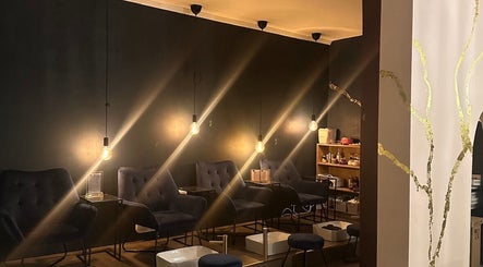 Chic seating at Nails and Cocktails by Rachel in Whitchurch, England, GB, with warm lighting and modern decor.
