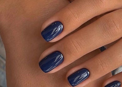 Close-up of elegant indigo nails beautifully manicured at N.SPA Mobile Beauty in London, England, GB.