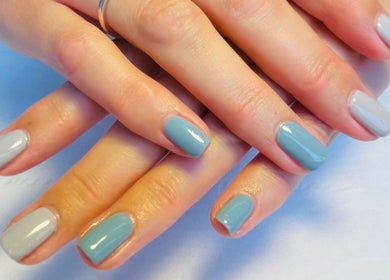Beautifully manicured hands with blue and grey nails at N.SPA Mobile Beauty, London, England, GB.