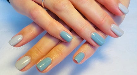 Beautifully manicured hands with blue and grey nails at N.SPA Mobile Beauty, London, England, GB.