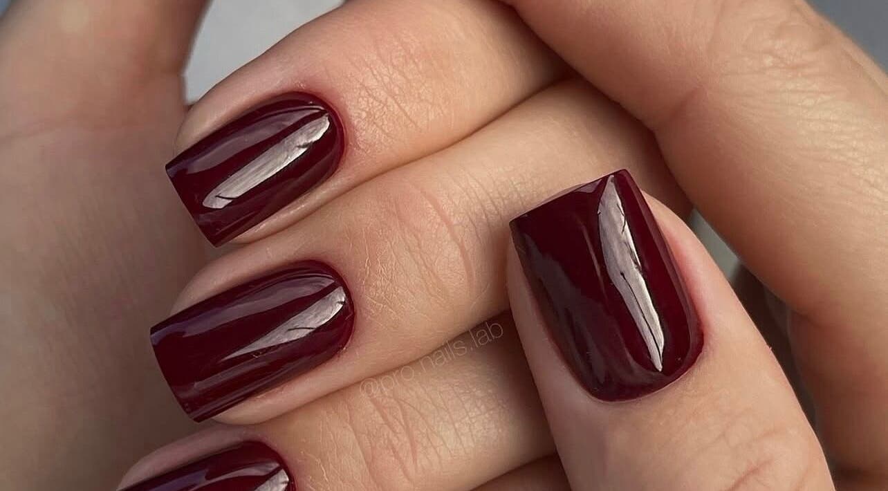 Burgundy manicure at N.SPA Mobile Beauty, London, England, GB showcasing glossy perfection.