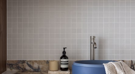 Elegant sink area at Kuyu Colonics in Turner, Australian Capital Territory, AU, featuring marble and modern fixtures.