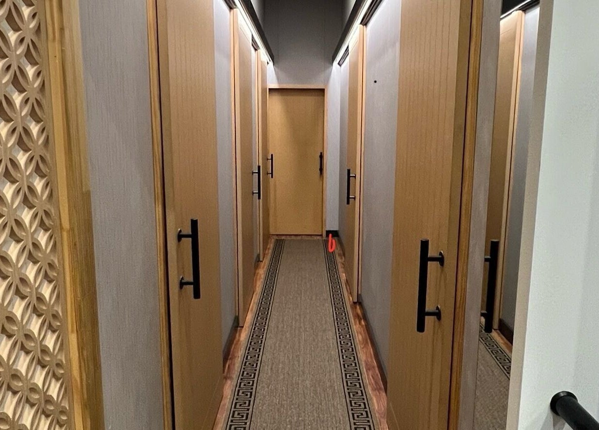 Serene hallway at Max Massage and Acupuncture in Cardiff, New South Wales, AU, featuring stylish wooden decor.