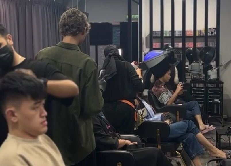 Guests enjoying hair treatments at Dee Kar Hair Salon, Cyberjaya, Selangor, MY, with attentive stylists.