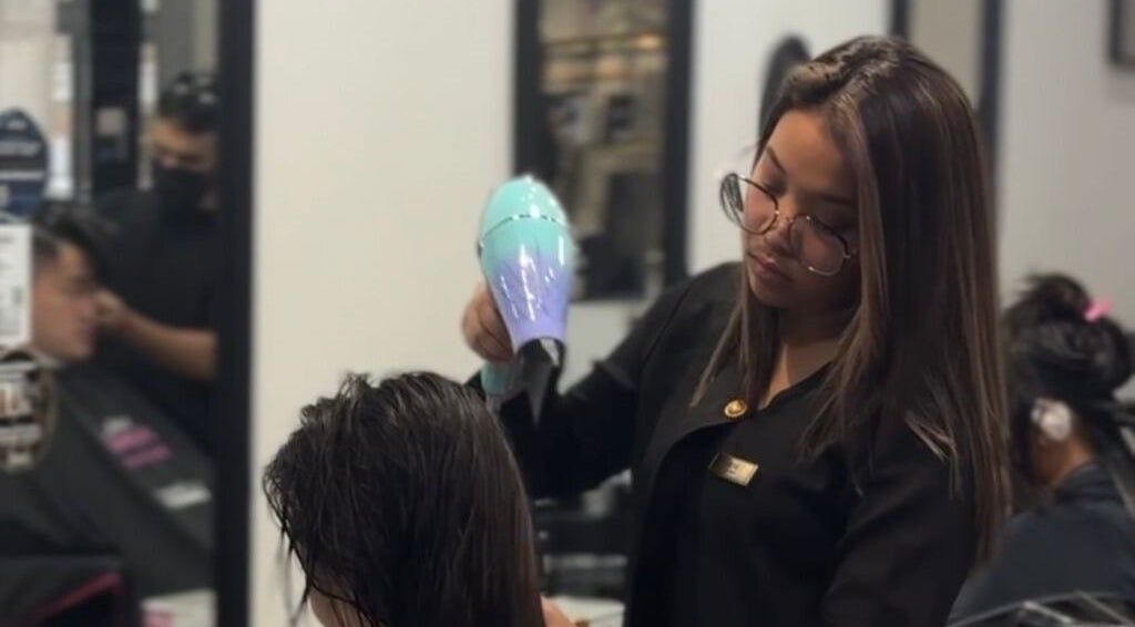 Expert stylist blow-drying hair at Dee Kar Hair Salon, Cyberjaya, Selangor, MY.