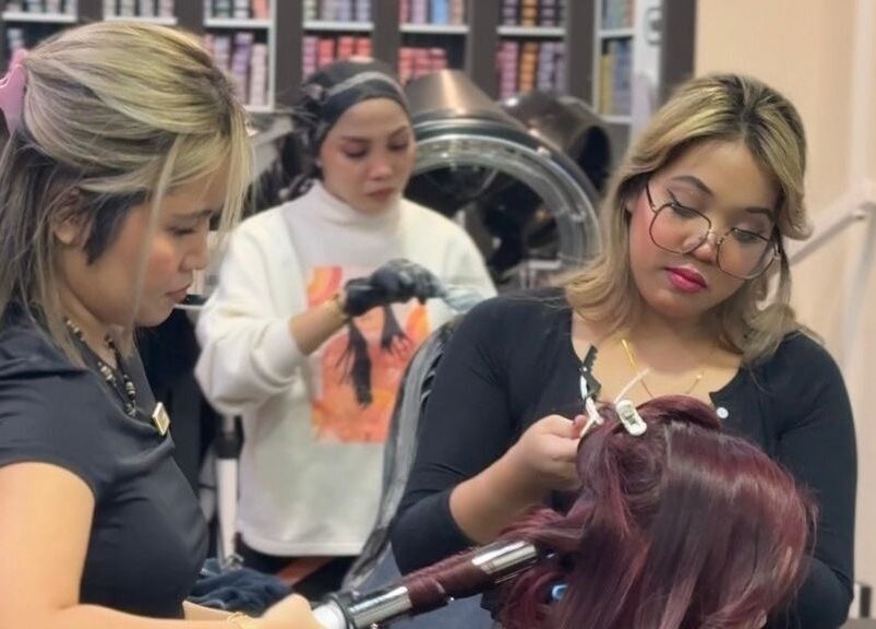 Stylists at Dee Kar Hair Salon in Cyberjaya, Selangor, MY expertly styling a client’s hair.