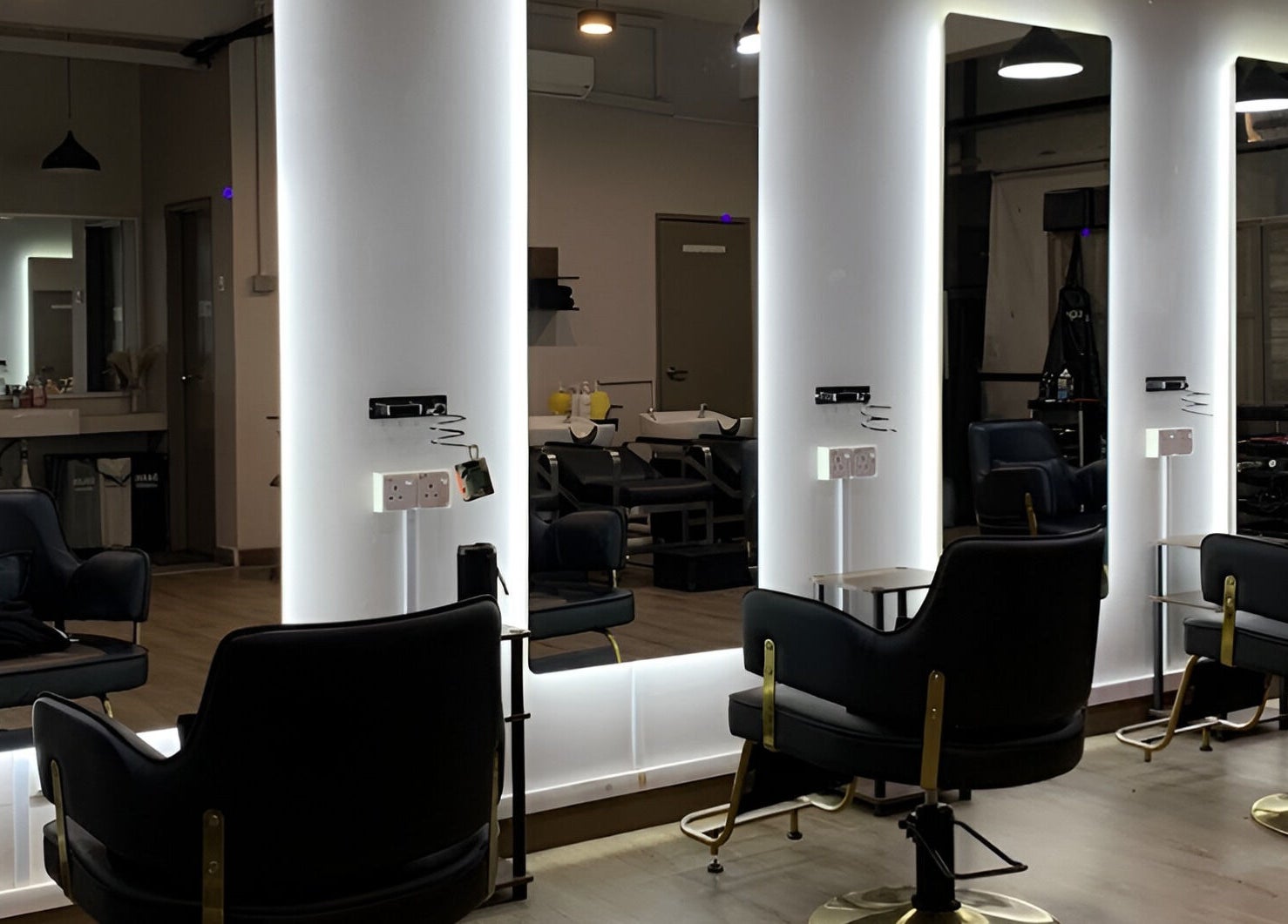 Modern styling chairs in Dee Kar Hair Salon (Lgk), Langkawi, Kedah, MY with illuminated mirrors.
