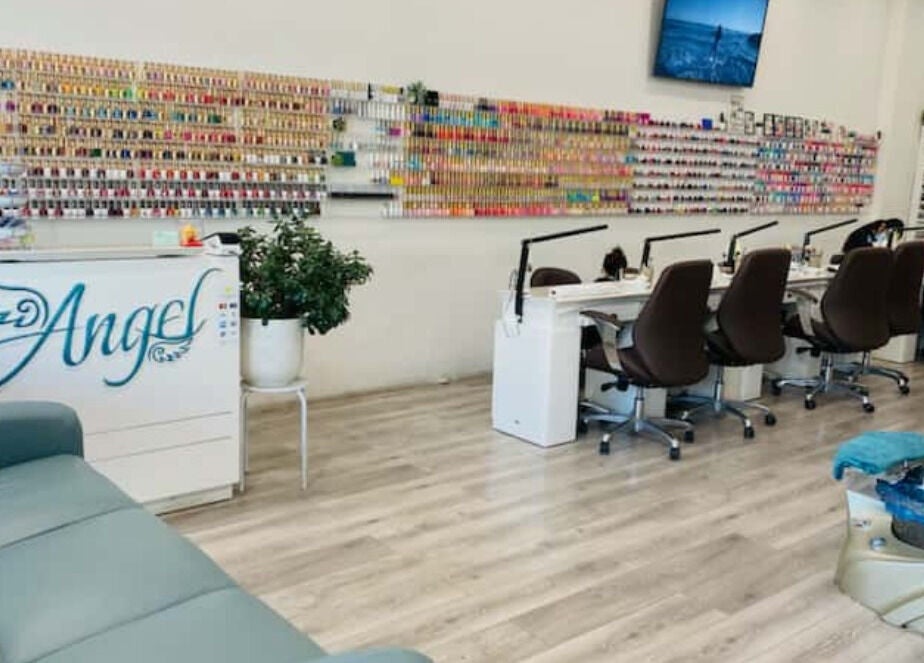 Interior of Angel Nail Spa & Beauty, Glenelg, South Australia, AU showcasing manicure stations and nail polish wall.