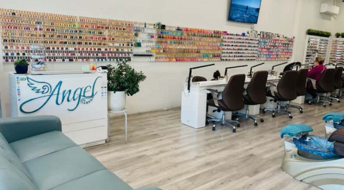 Interior of Angel Nail Spa & Beauty, Glenelg, South Australia, AU showcasing manicure stations and nail polish wall.