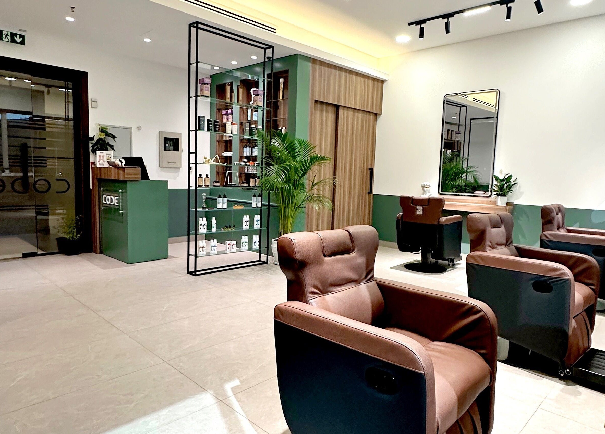 Relaxing interior of The Barber Code Gents Salon, Dubai, Dubai, AE, featuring plush chairs and modern decor.