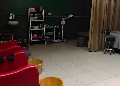 Relaxing treatment area at Efyza Salon, Sungai Petani, Kedah, MY showcasing comfortable chairs and a massage bed.