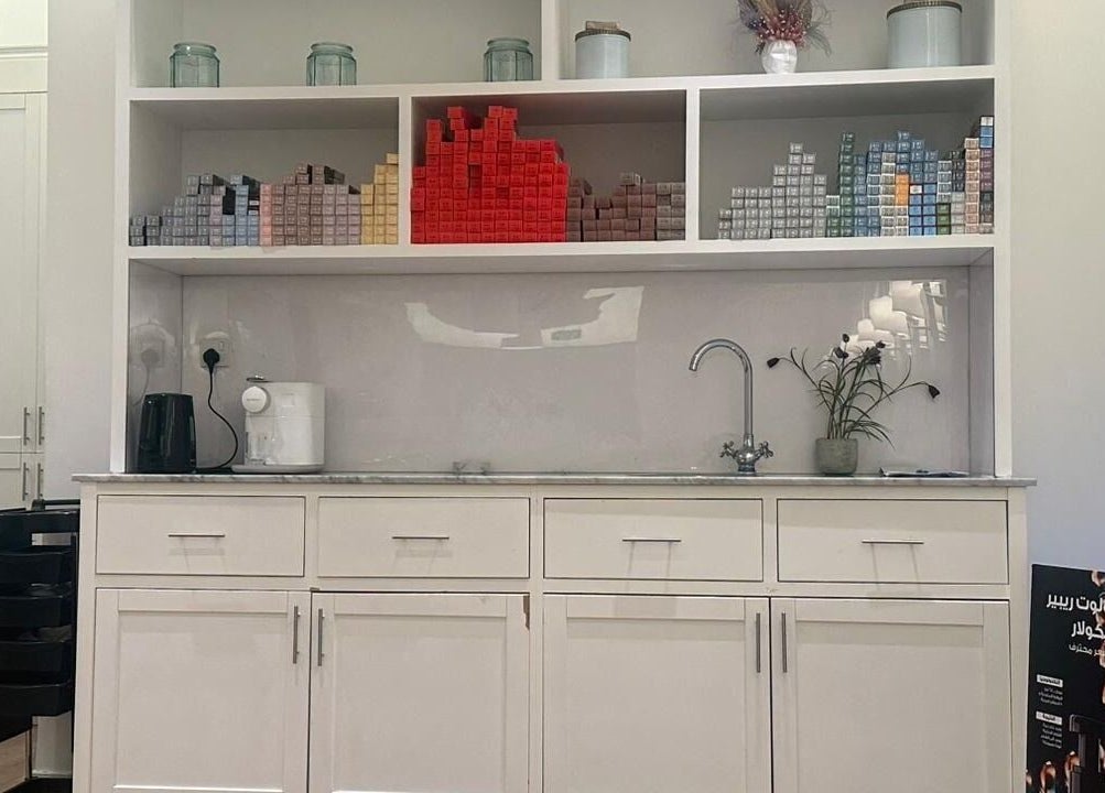 Stylish shelves at Blowrious, الرياض, منطقة الرياض, SA, displaying beauty products and a coffee maker.