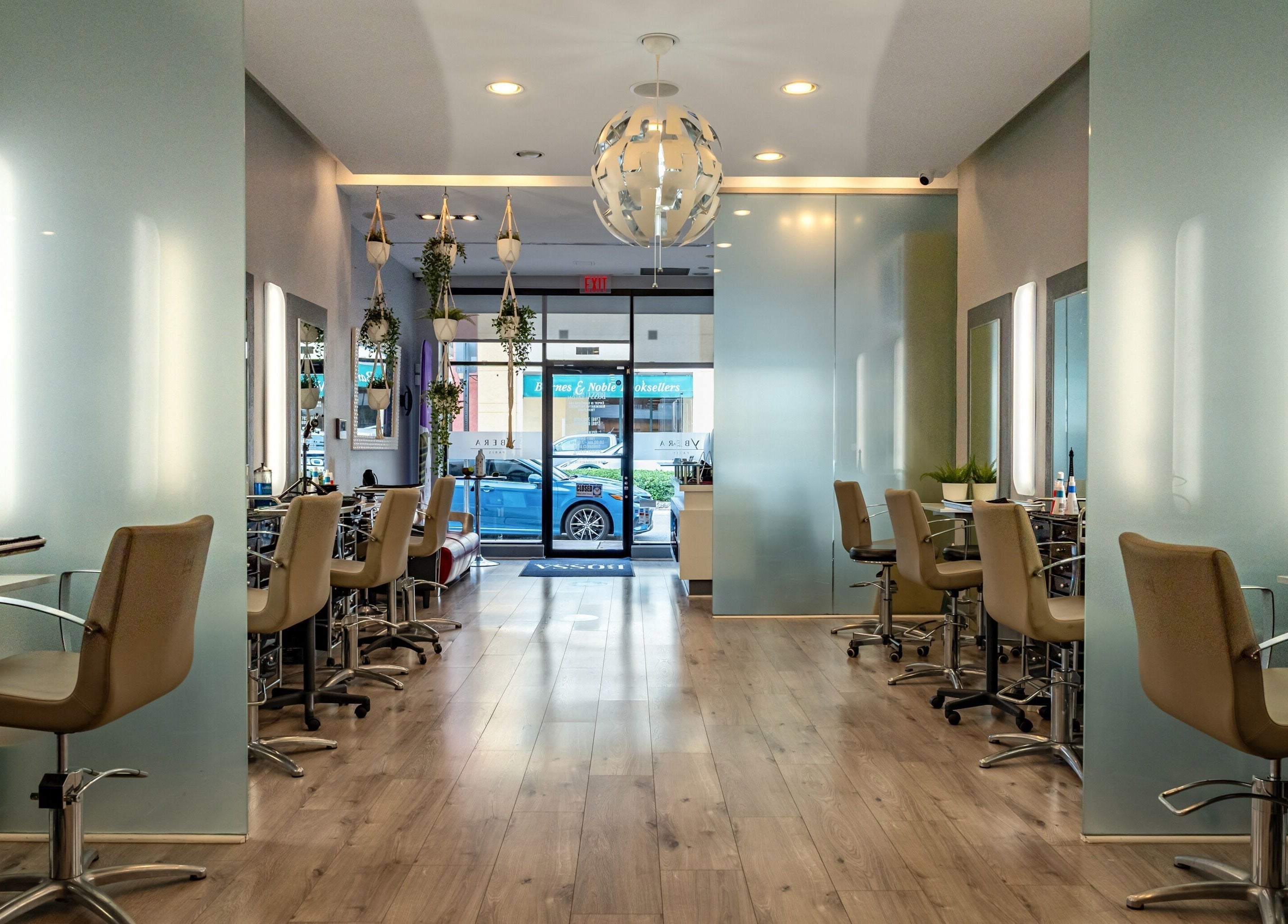 Interior moderno de BOSSA HAIR SALON LLC en Coral Gables, Florida, US, con sillas y espejos elegantes.