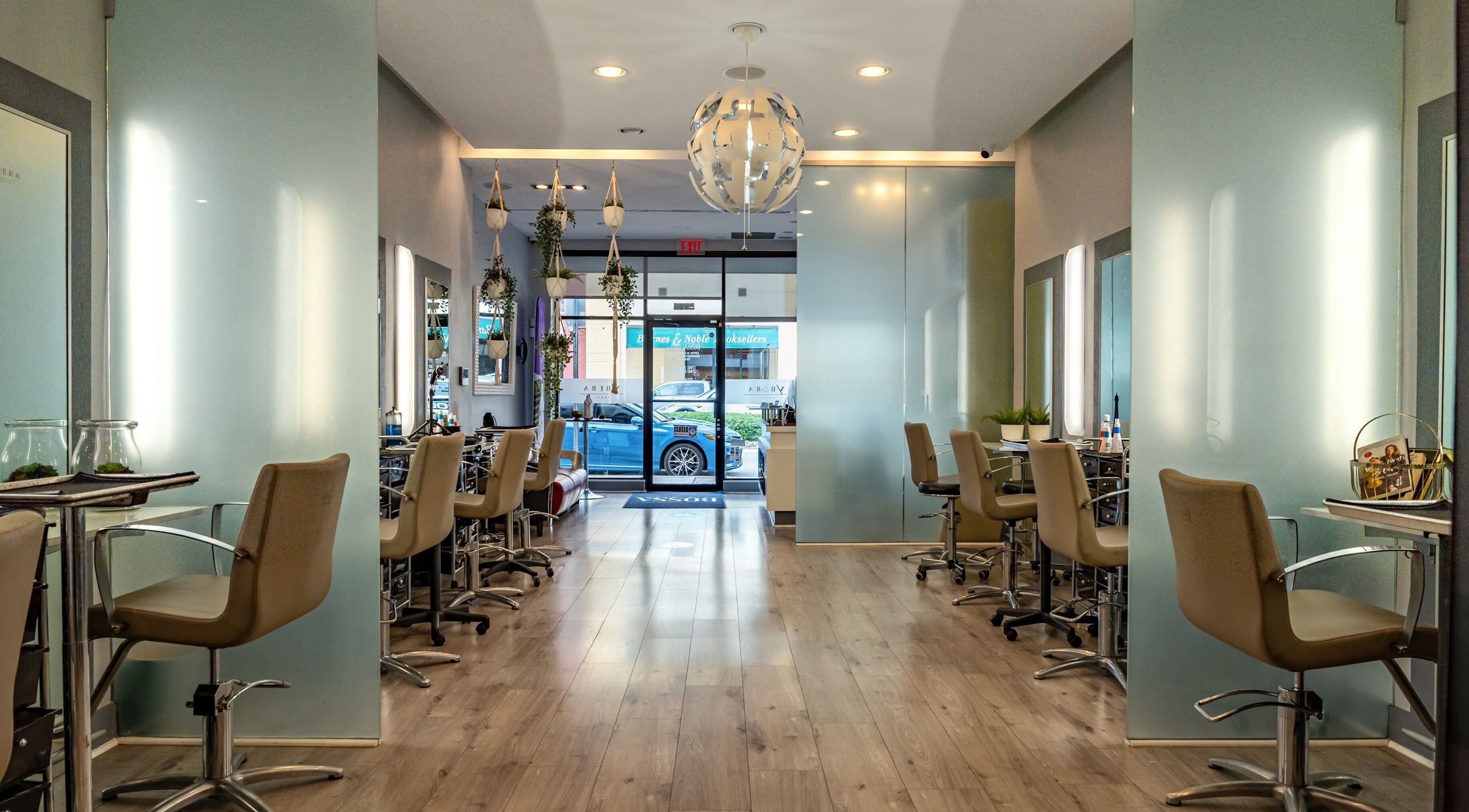Interior moderno de BOSSA HAIR SALON LLC en Coral Gables, Florida, US, con sillas y espejos elegantes.