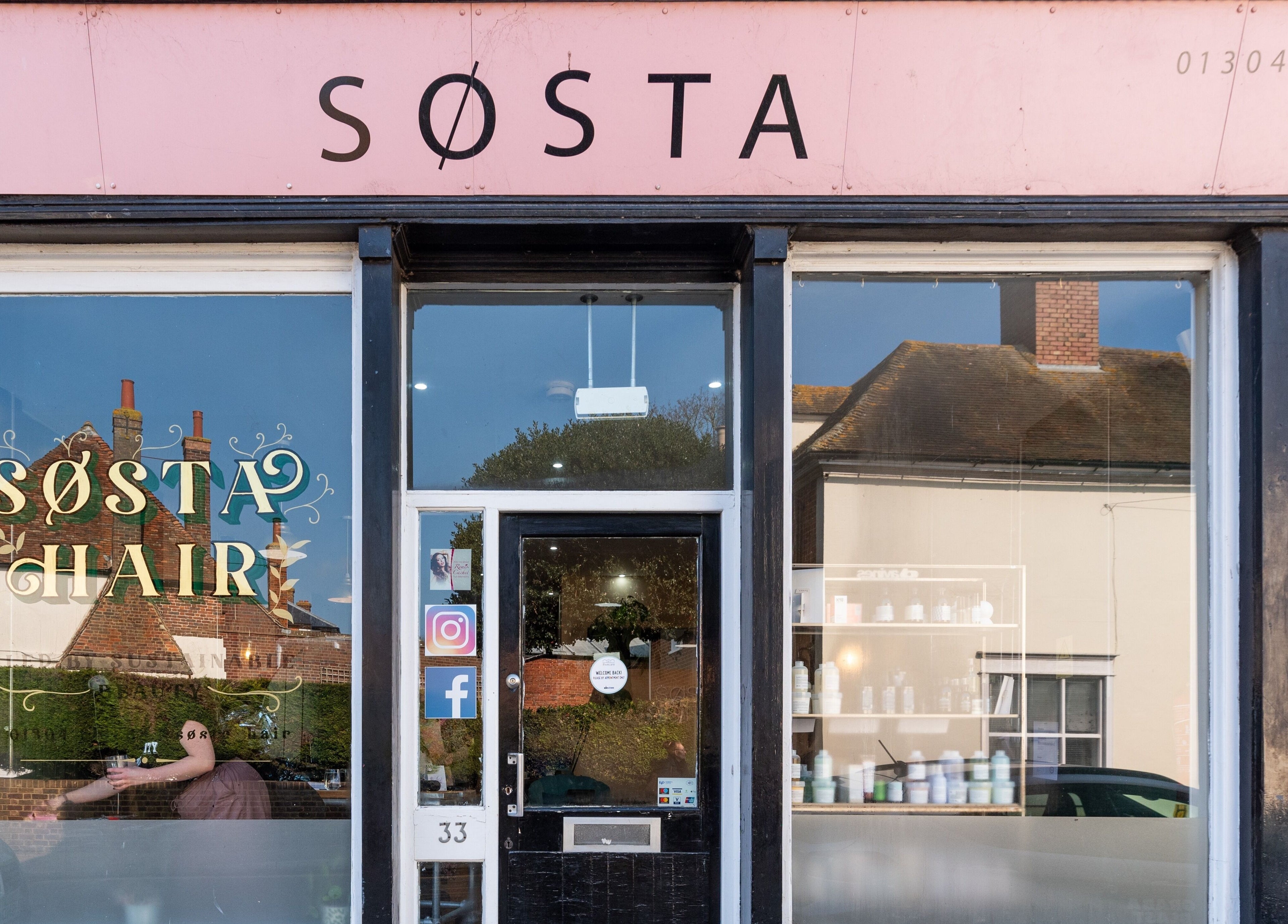 Exterior view of Sosta beauty venue in Ash, England, GB showcasing stylish window design.