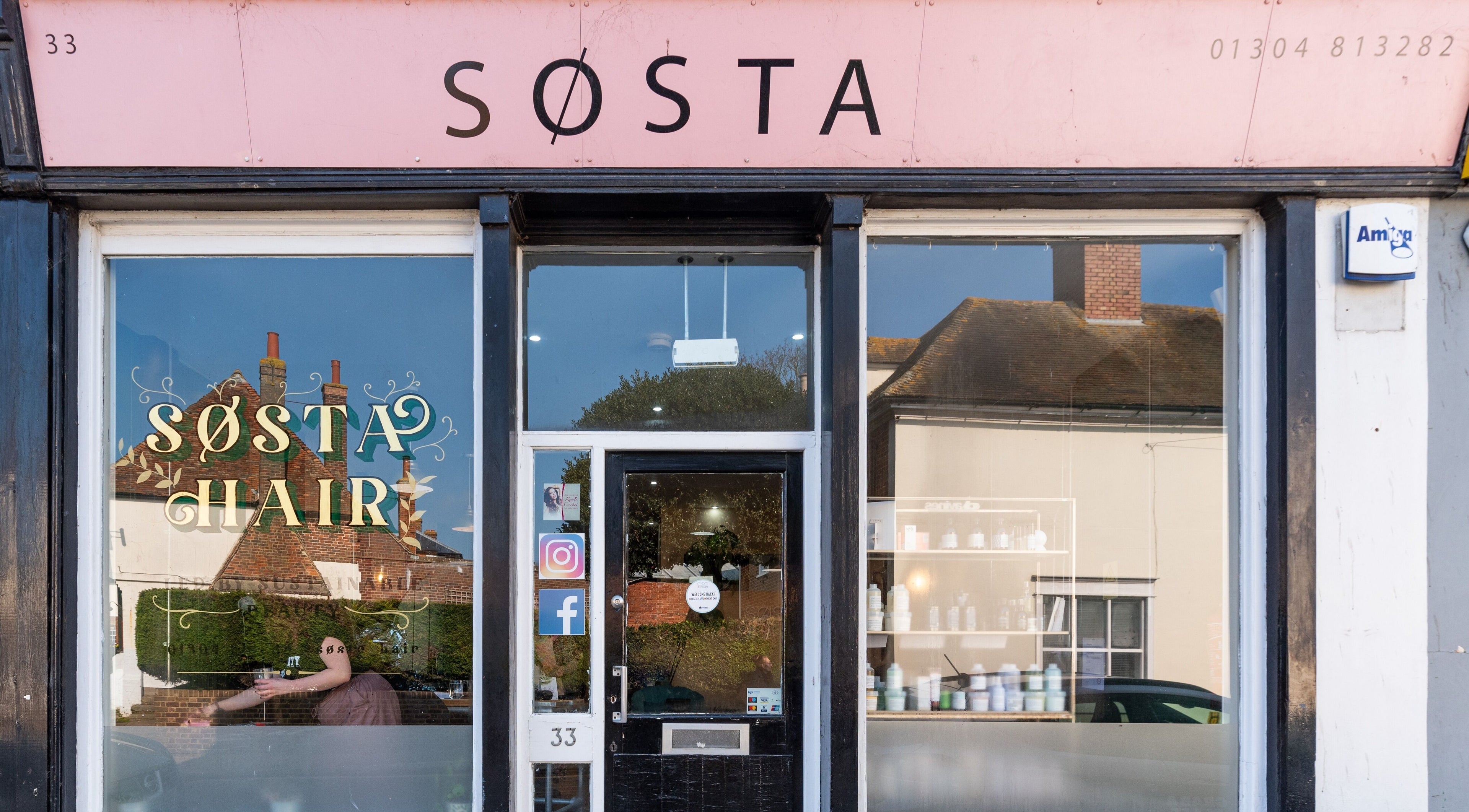 Exterior view of Sosta beauty venue in Ash, England, GB showcasing stylish window design.