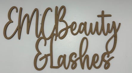 Wooden sign of EMC Beauty And Lashes in Poyntzpass, Northern Ireland, GB on a white background.