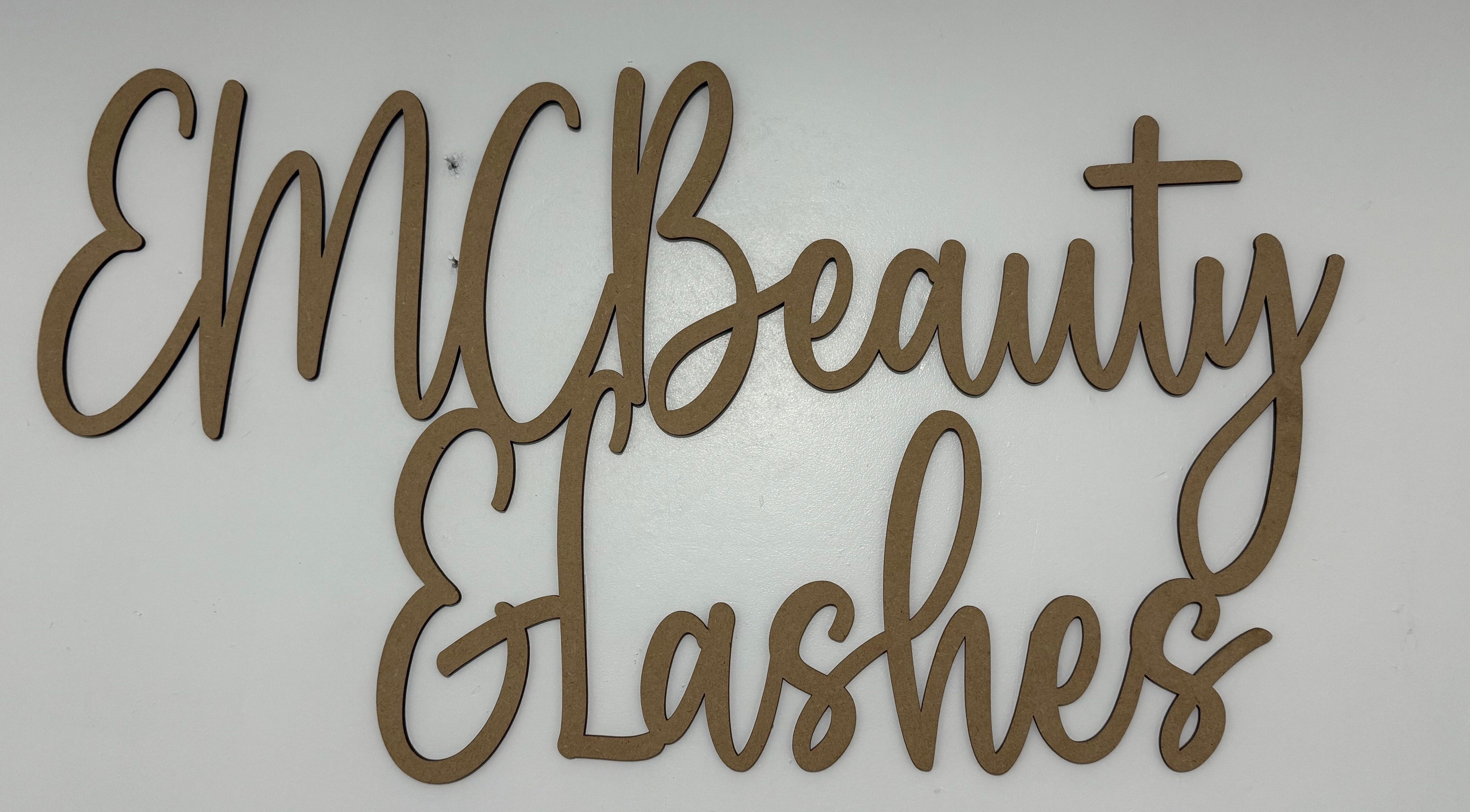 EMC Beauty And Lashes logo sign on white wall at Poyntzpass, Northern Ireland, GB.