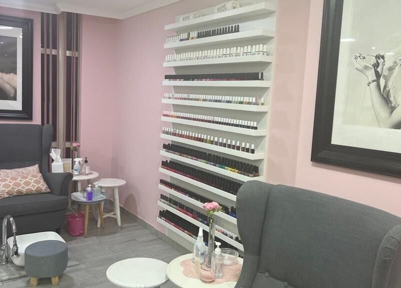 Relaxing pedicure chair at Sugarcoat Nails, Abu Dhabi, surrounded by stylish decor and nail polish wall.