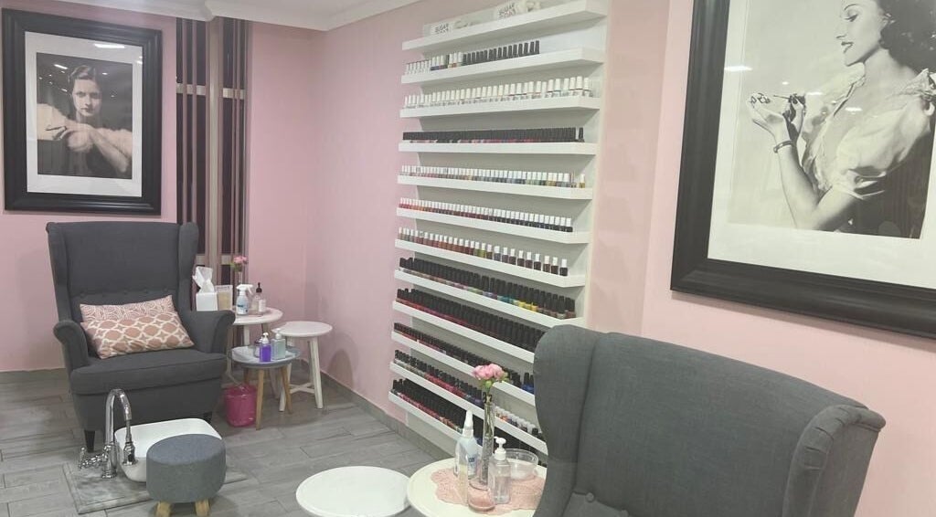 Relaxing pedicure chair at Sugarcoat Nails, Abu Dhabi, surrounded by stylish decor and nail polish wall.