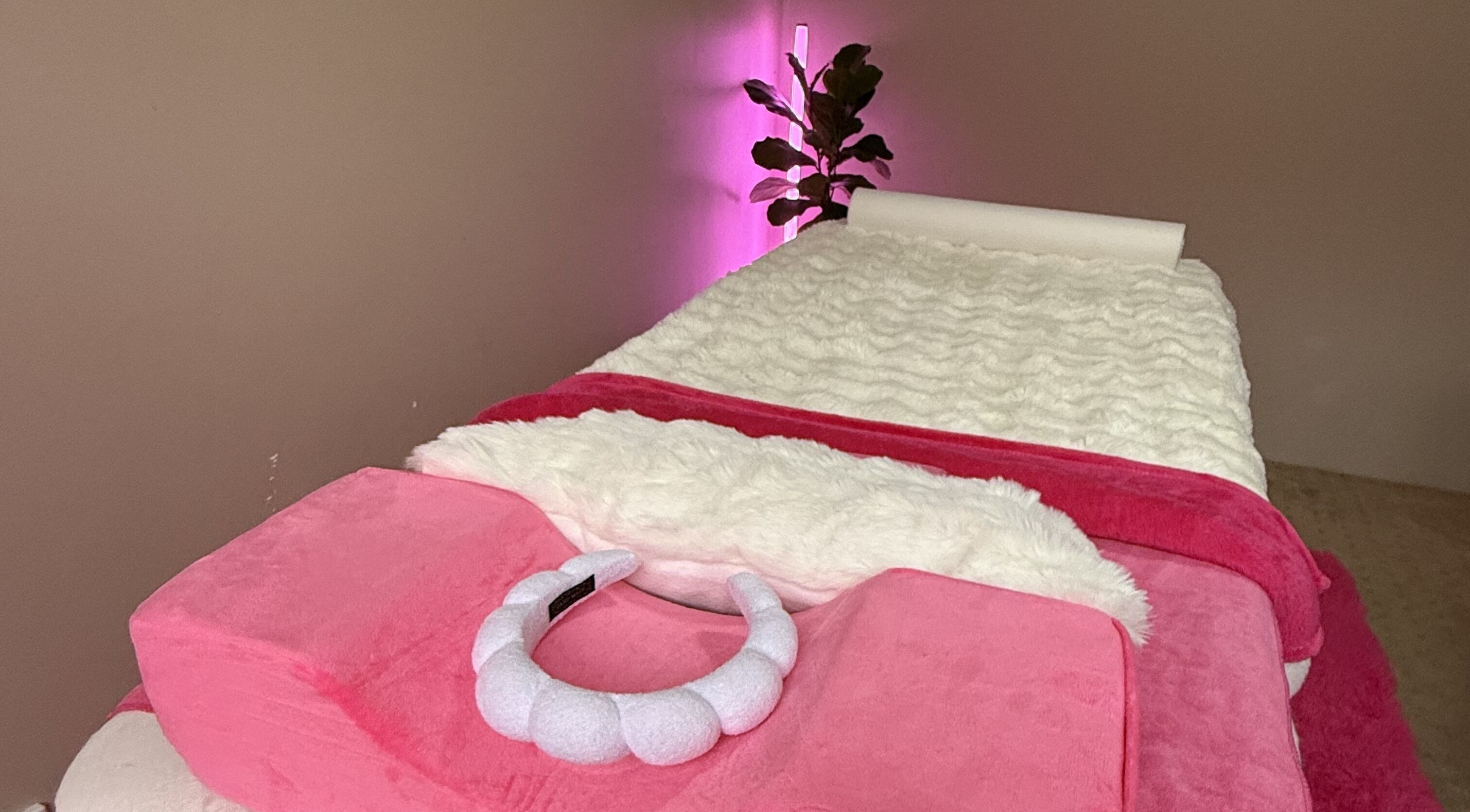 Luxurious spa bed with plush pink linens at Baddie Beauty in Wannanup, Western Australia, AU.