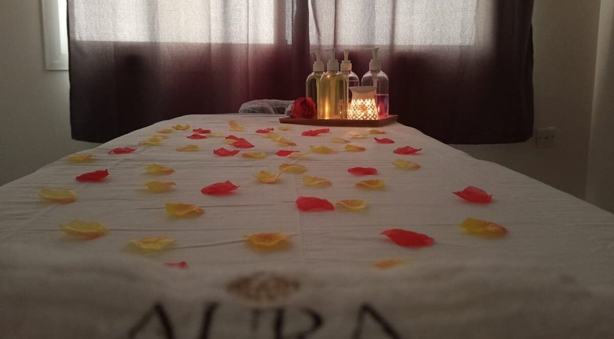 Massage table with rose petals and oils at Aura Beauty Massage, Doha, Doha Municipality, QA.