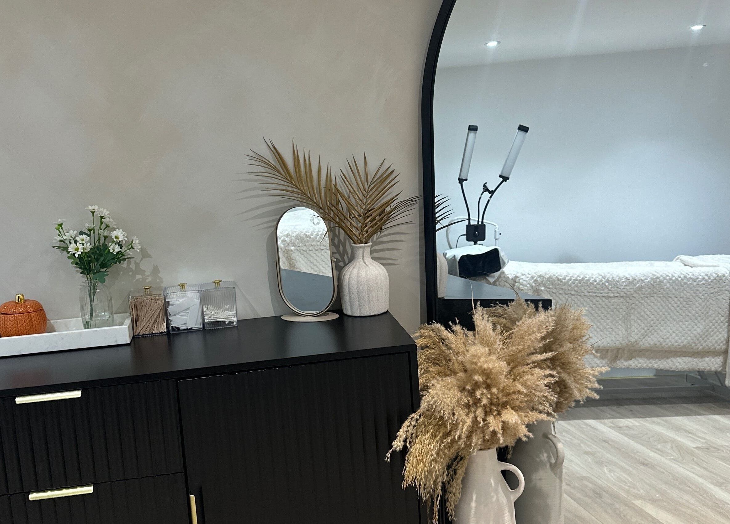 Elegant treatment room at Lashed by Aimee in Nuneaton, England. Features stylish decor and cozy bed.