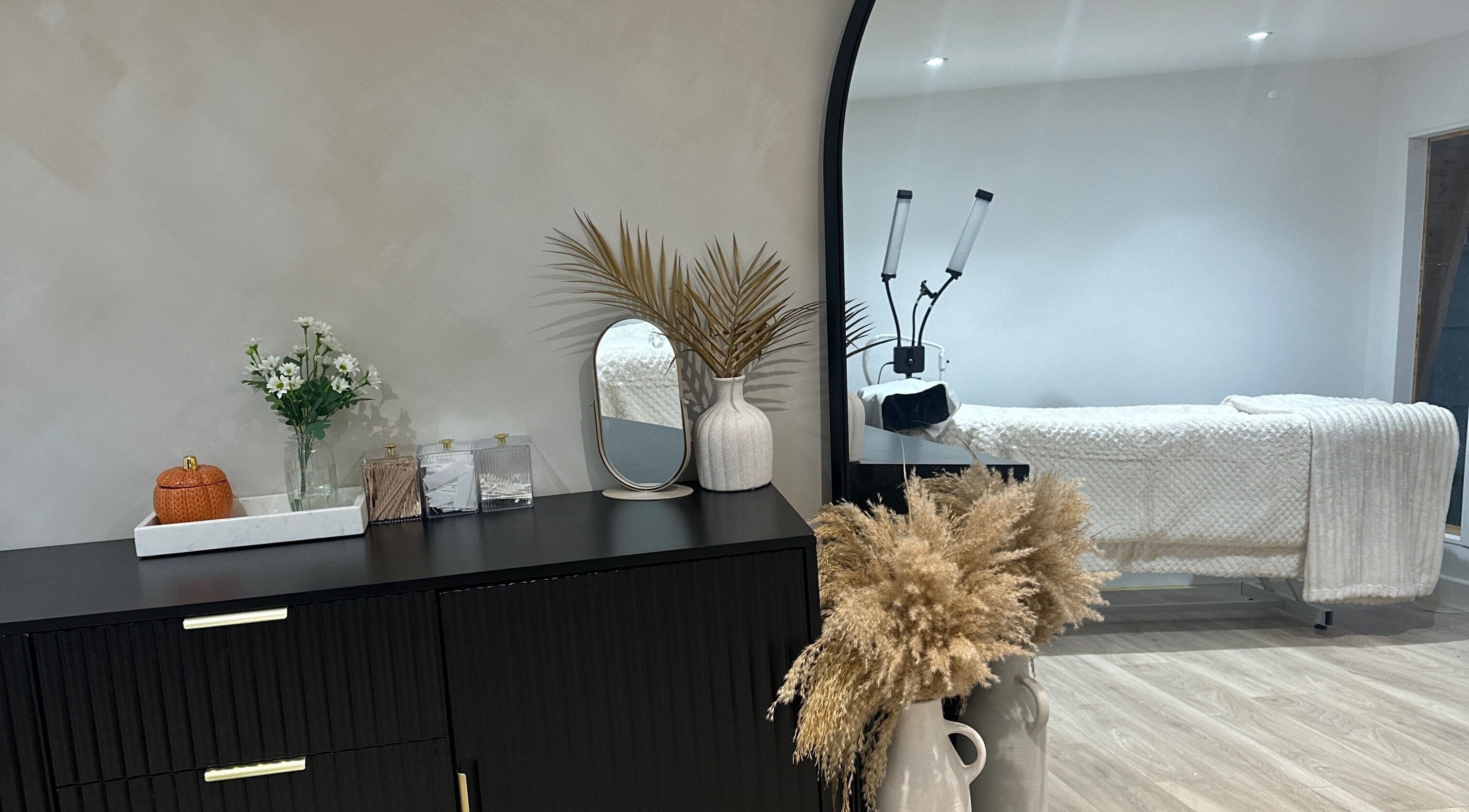 Elegant treatment room at Lashed by Aimee in Nuneaton, England. Features stylish decor and cozy bed.