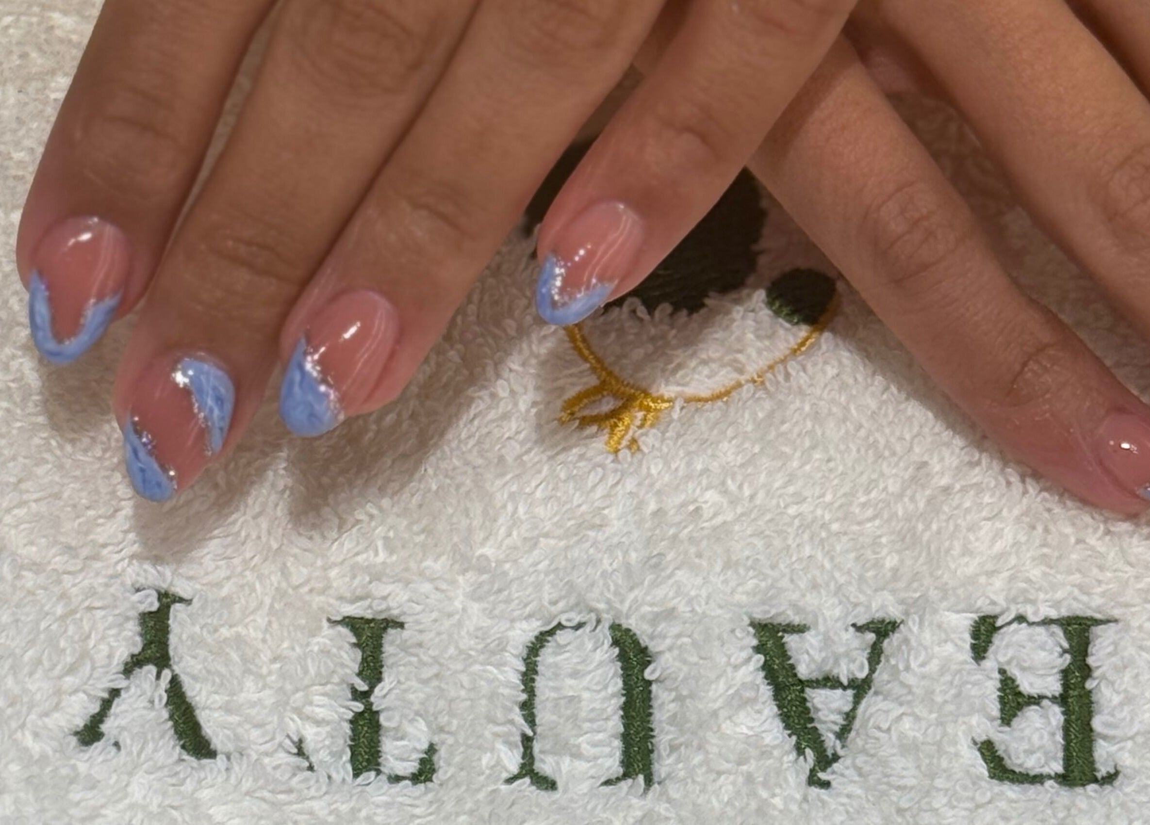 Elegant blue nail art on hands at Salon & Yello Spa in Riyadh, Riyadh Province, SA.