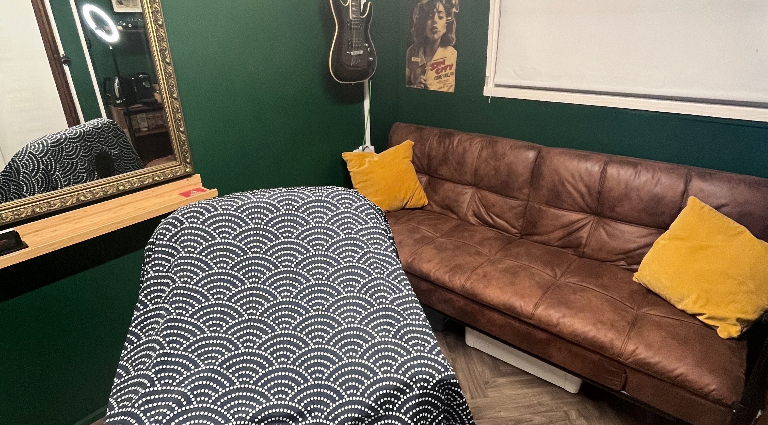 Cozy interior of Cabin Barbers in Chessington, England, GB, featuring a modern sofa and stylish decor.