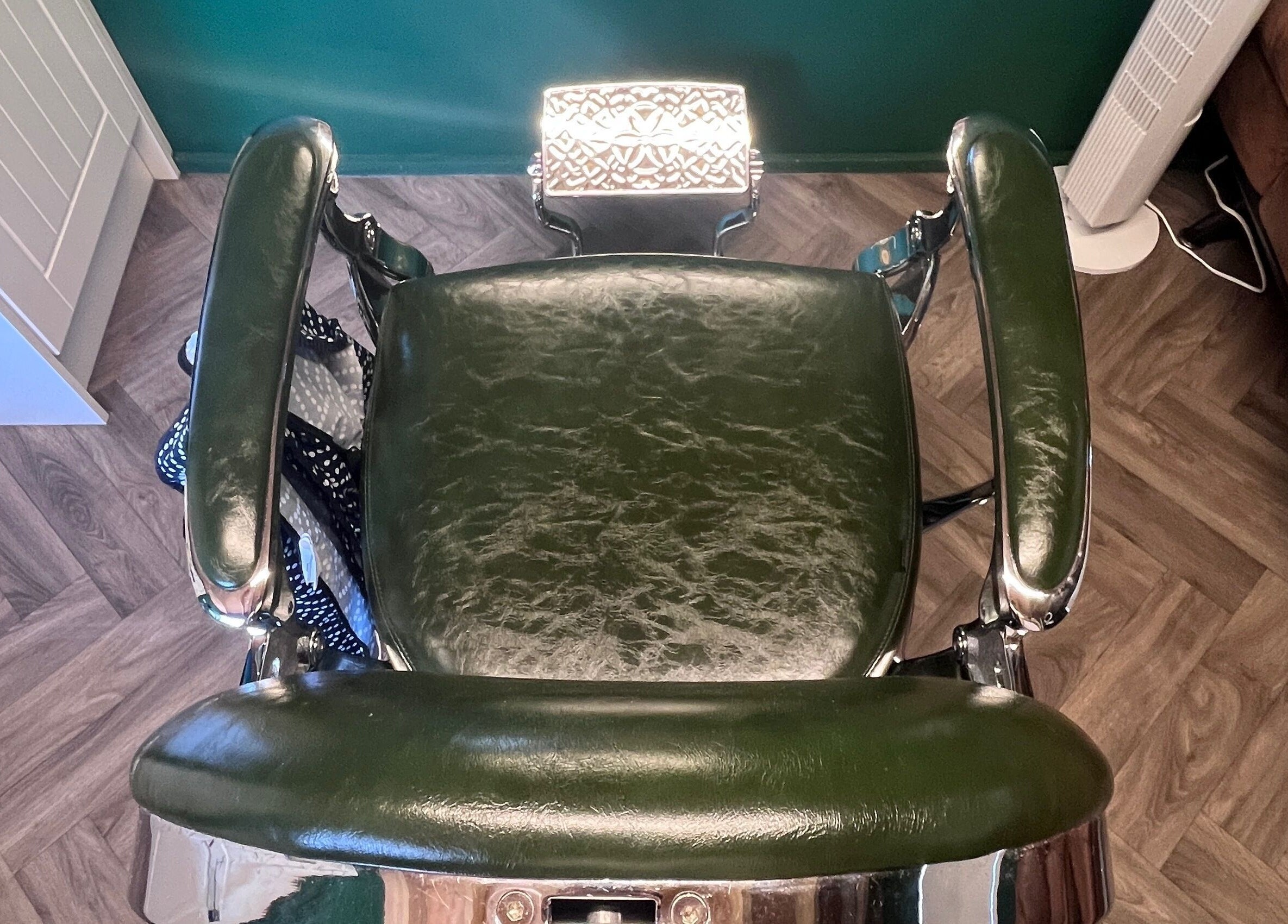 Classic vintage barber chair at Cabin Barbers, Chessington, England, GB, showcasing luxury and style.