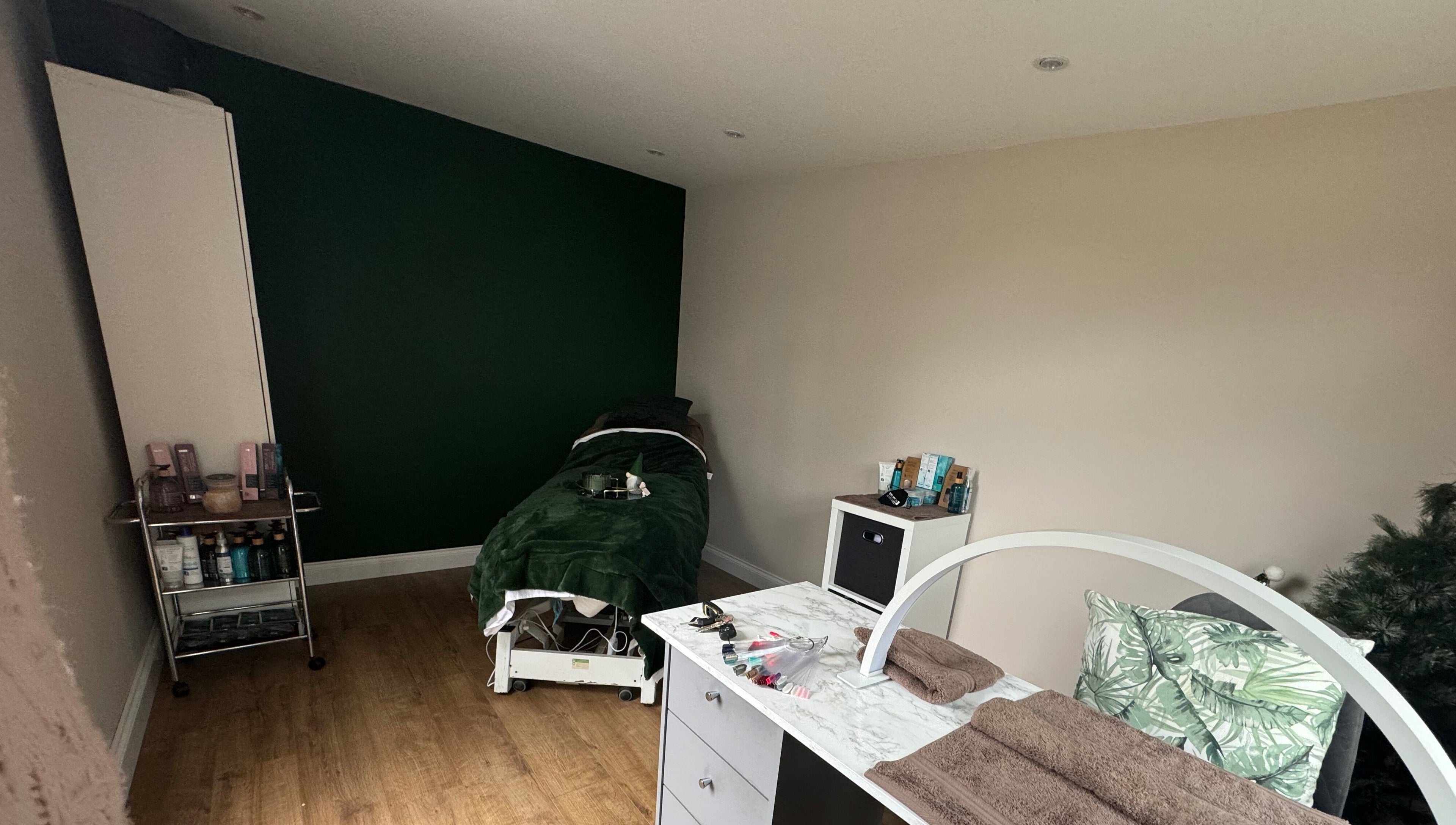 Relax & Rewind's serene treatment room in Willesborough, England, GB, with massage bed and beauty essentials.