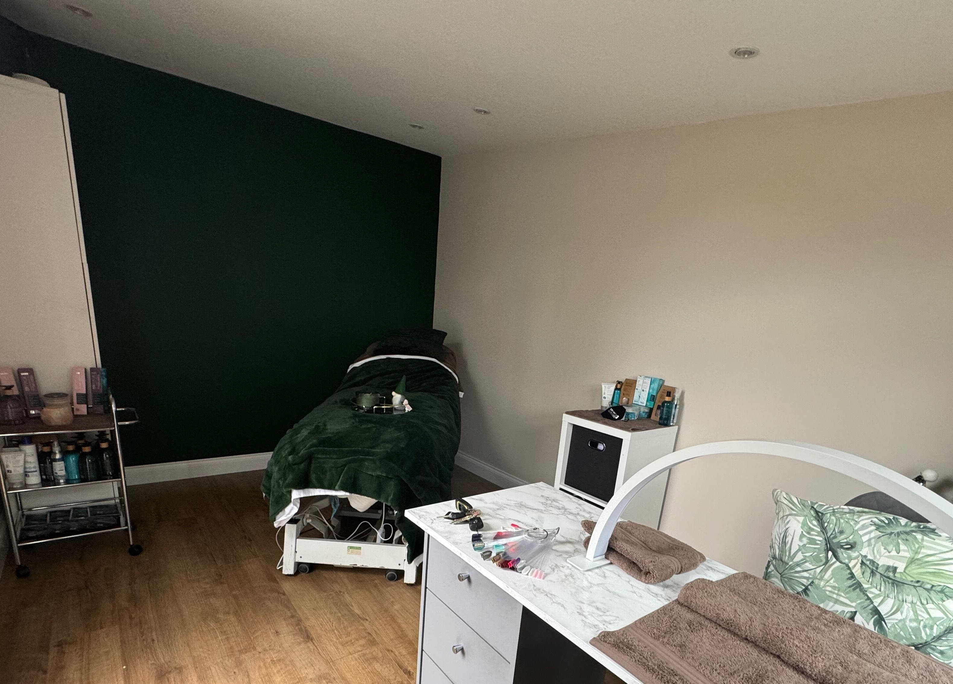 Relax & Rewind's serene treatment room in Willesborough, England, GB, with massage bed and beauty essentials.