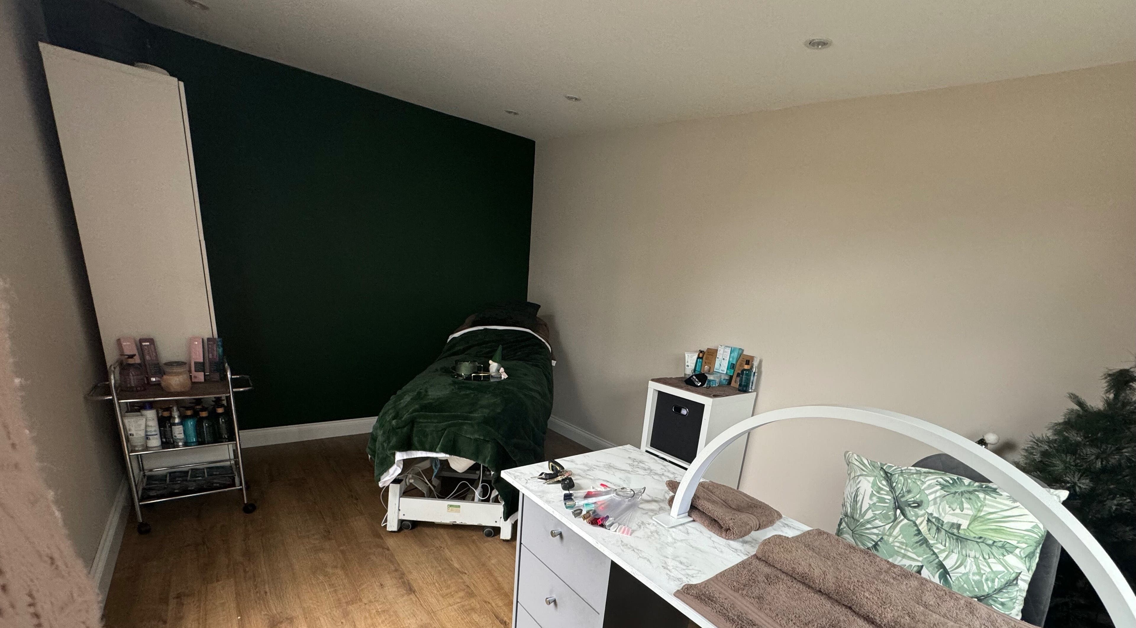 Relax & Rewind's serene treatment room in Willesborough, England, GB, with massage bed and beauty essentials.