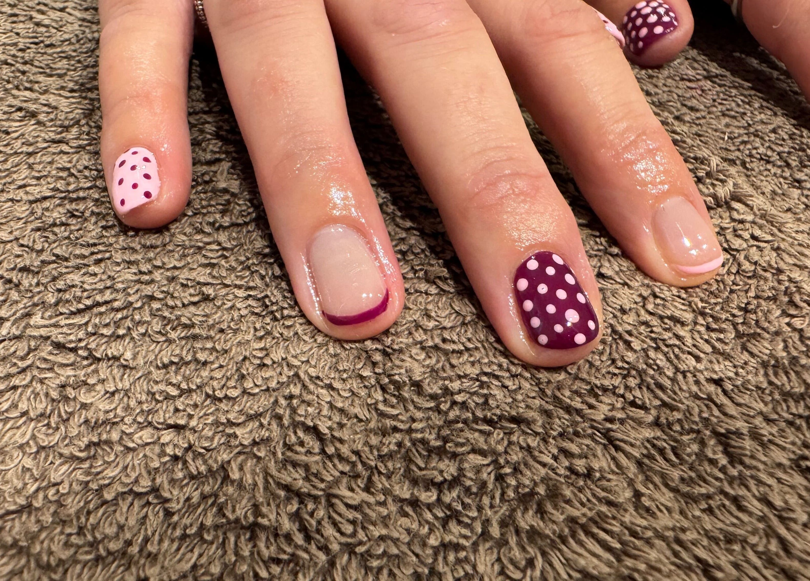 Stylish polka-dot and French tip nail designs at Relax & Rewind, Willesborough, England, GB.