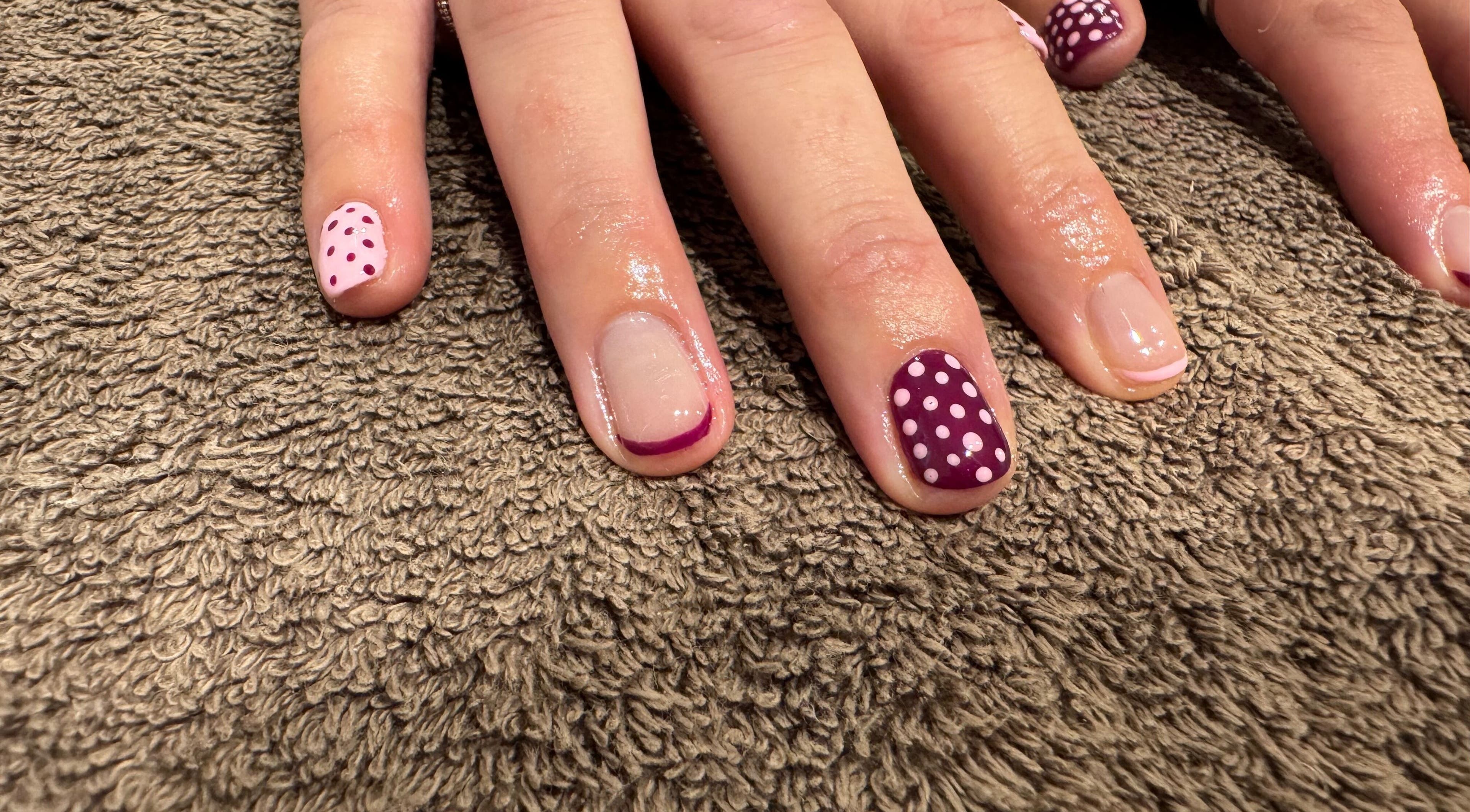 Stylish polka-dot and French tip nail designs at Relax & Rewind, Willesborough, England, GB.