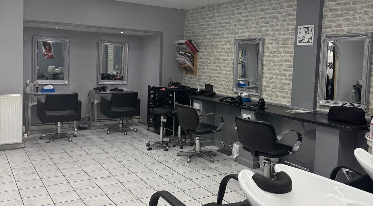 Modern salon interior at Anjels Hair and Beauty, Crawley, England, GB, featuring chic styling stations and mirrors.