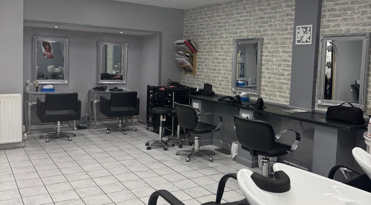 Modern salon interior at Anjels Hair and Beauty, Crawley, England, GB, featuring chic styling stations and mirrors.