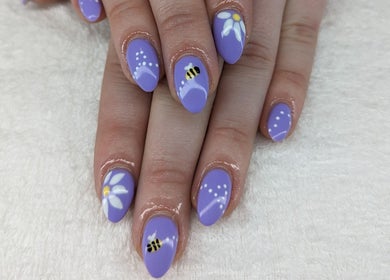 Artistic lavender nails with bee and daisy designs at Enchanted Nails, Kelowna, British Columbia, CA.